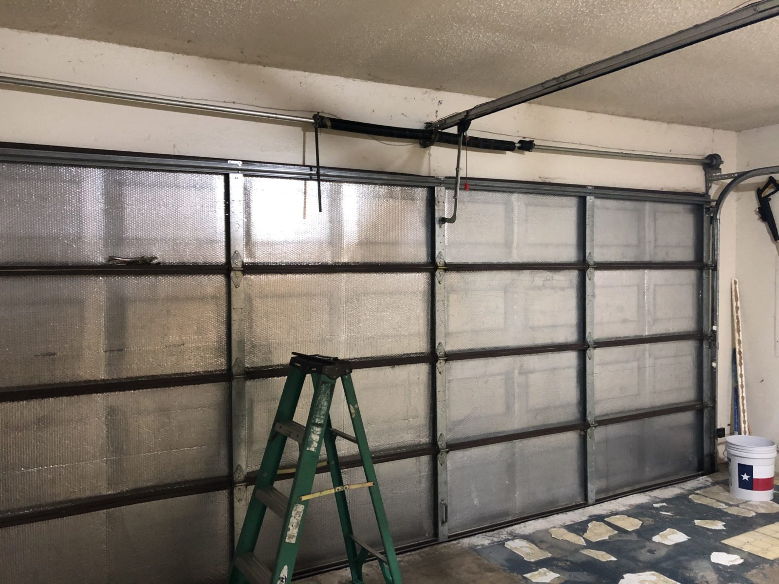 Commercial garage door technician servicing an overhead rollup door