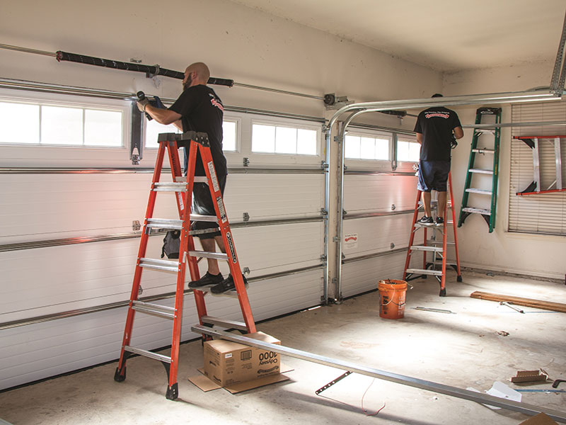 Garage door technician working on residential overhead door in Arcadia, Florida